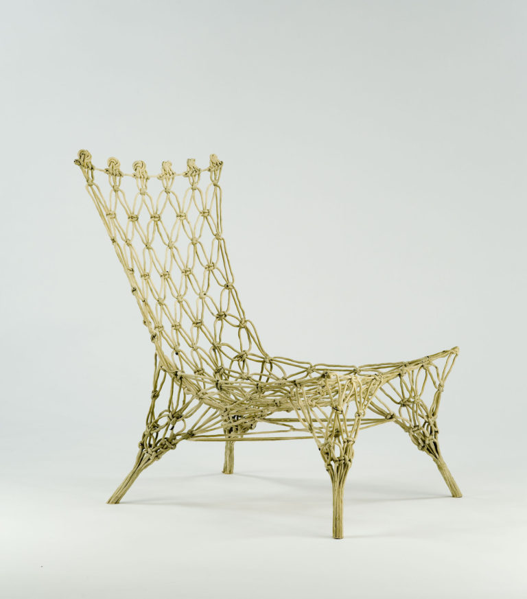 Chair formed of stiffened knotted rope, similar to a macramé net frozen in space.