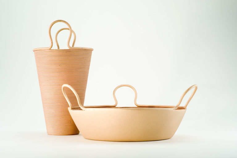 Tall straw-colored conical vase and wide conical basket, both straw-colored with handles.