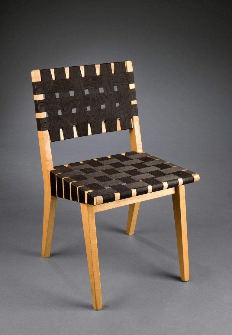Chair with a simple wooden frame with seat and back formed by woven strips of plastic webbing.