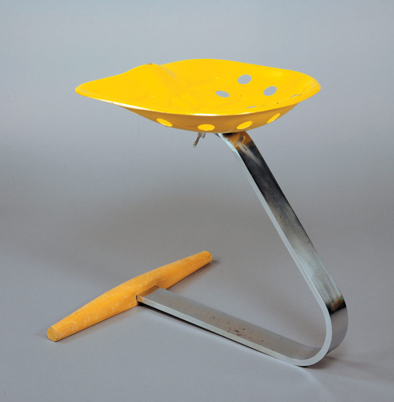 Stool with a wood and strap-steel base supporting an old-fashioned metal tractor seat in bright yellow.