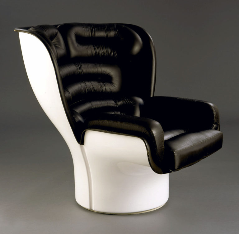 Large armchair with solid white fiberglass frame and thick cushioning covered in black leather.