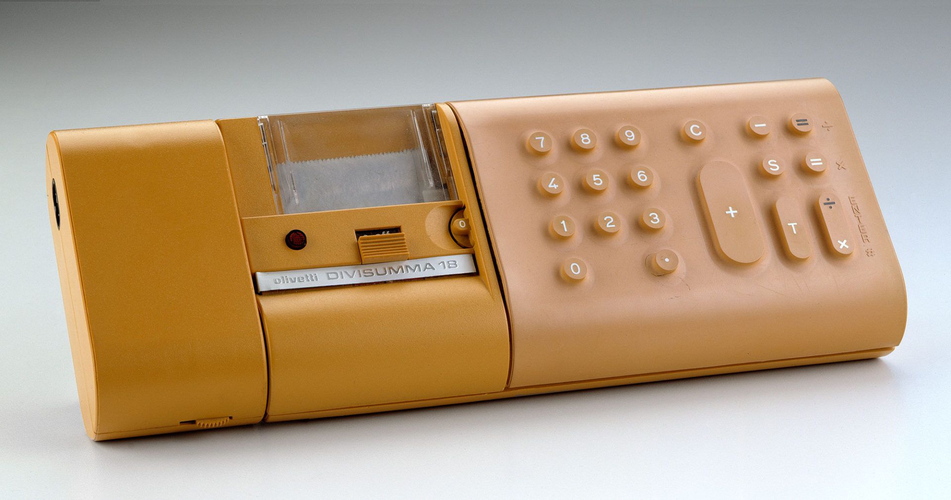 Horizontal rectangular calculator with rounded corners in yellow plastic and rubber. Buttons on right and printer section at center.