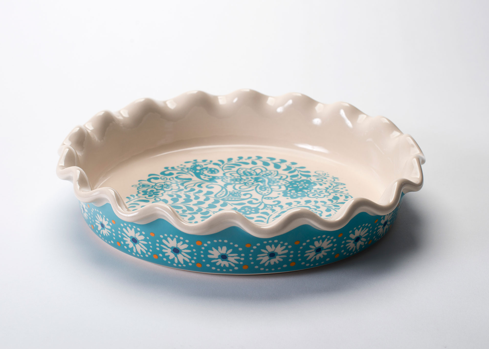 Plate with blue floral decoration and ruffled edge.