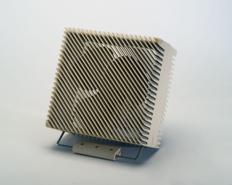 White square table fan with diagonal slats on the front of the casing.